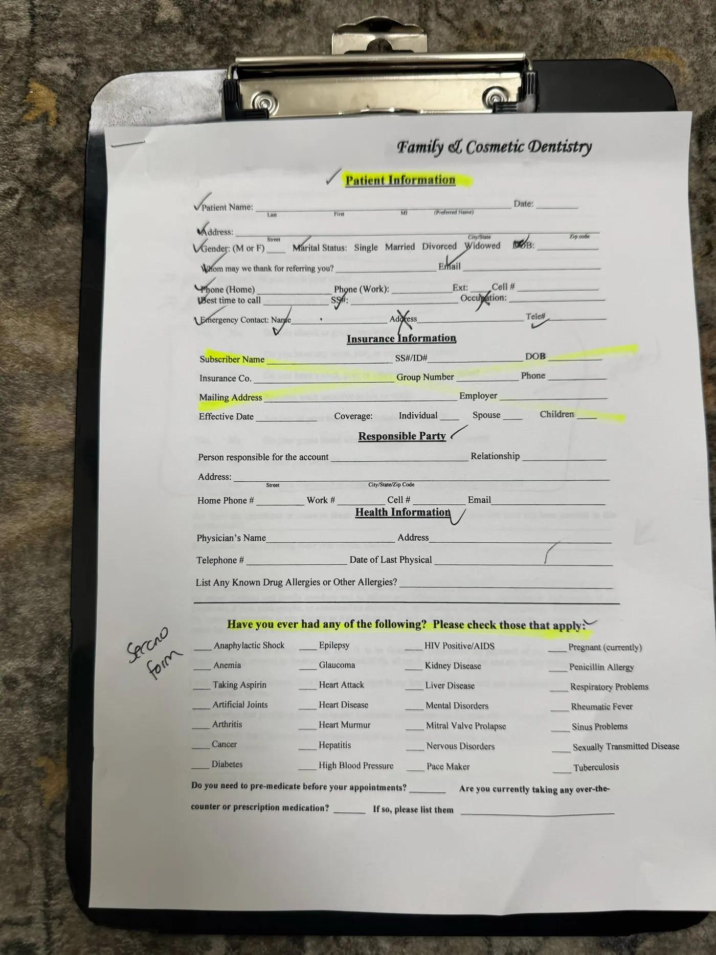 A blank dental patient intake form on a clipboard, asking for name, address, Social Security number, date of birth, insurance details, and a health history checklist that includes HIV status, hepatitis and pregnancy.
